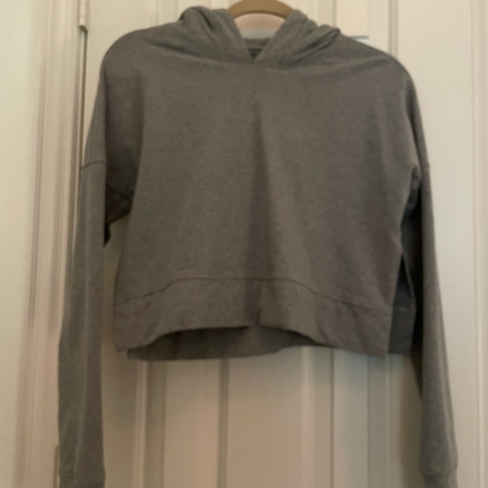 Lululemon cropped gray hoodie with side slits.